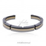 A stainless steel bracelet covered with silver, gold and black enamel