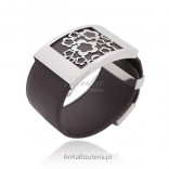 Jewelery. Avant-garde big bracelet made of leather and stainless steel. Flowers