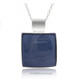 A large silver pendant with a blue stone jewelry. Classic elegant jewelry.