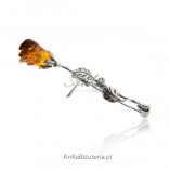 Silver rose brooch with amber