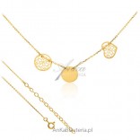 A gold necklace with three tags
