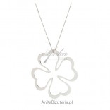 A long silver necklace with a large clover