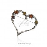 Silver brooch with amber. Heart