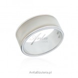 A silver ring with white enamel