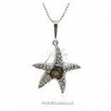 A silver starfish with amber and cubic zirconia