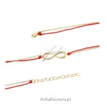 Silver gilded infinity bracelet on a red string
