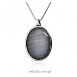 Silver pendant with gray uleksite with "cat's eye" effect