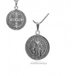 A large silver medallion oxidized with Saint Benedict