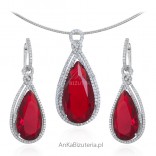 Elegant set of silver jewelry with red zircon