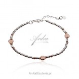 Silver bracelet with gold-plated hearts in pink