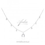 A beautiful silver necklace with amulet of happiness - an anchor and white ccyrkoniamii