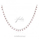 A silver necklace with maroon cubic zirconia