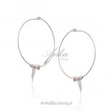 Silver earrings with a hanging wing