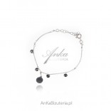 Silver bracelet with a circle and black zircons