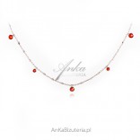 A subtle silver necklace with red corals