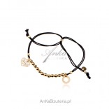 Silver bracelet, gold-plated balls on a black string with a heart and a circle
