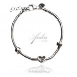 Silver bracelet with a heart with a serpentine weave