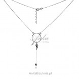 Silver circle necklace with a hanging wing and a zircon