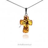 A silver cross with amber