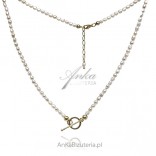 Gold-plated silver necklace with white pearls on a tibon