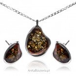 A set of silver jewelry with cherry amber with scales