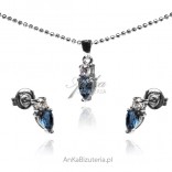 A set of silver jewelry with a blue zircon