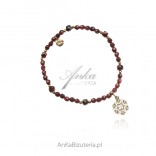 Silver bracelet with garnet and gold-plated rosette