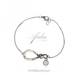 Silver infinity bracelet with white opal