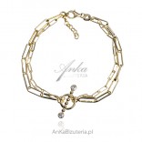 Gold-plated silver bracelet with decorative tibon on a fleat chain