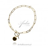 Silver bracelet gold plated rolo flute with a ball