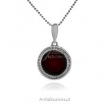 Round silver pendant with cherry amber