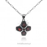 A silver pendant with a real garnet