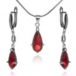 Elegant silver jewelry with a red zircon