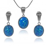 A set of silver jewelry with blue oval opal