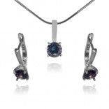 A subtle set of silver jewelry with a heliotrope-colored crystal