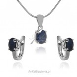 A set of silver jewelry with a natural sapphire