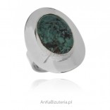 A silver ring with turquoise, with an original size 14 plate