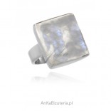 A silver ring with a moonstone in a delicate silver setting