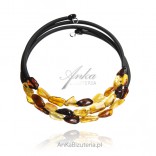 Bracelet with cognac, cherry and yellow amber on a black rubber spring