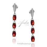 Silver earrings with red zircons