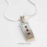 A beautiful silver pendant with pomegranates with a Greek pattern