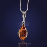A sophisticated, fashionable silver pendant with natural amber.